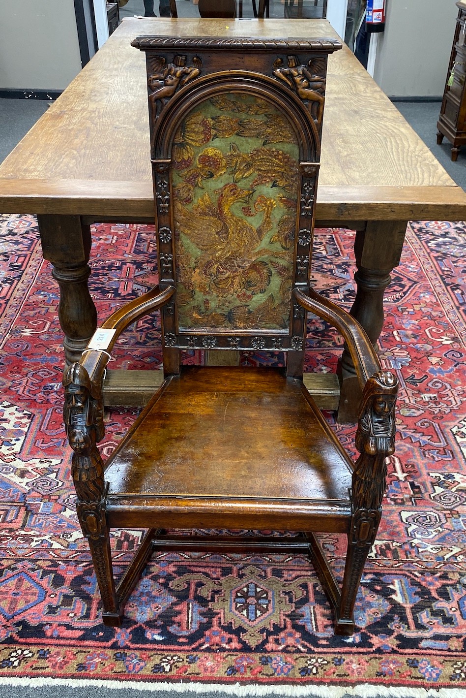 A 20th century carved mahogany cacqueteuse (armchair) with painted leather panelled back, width 54cm, depth 42cm, height 111cm